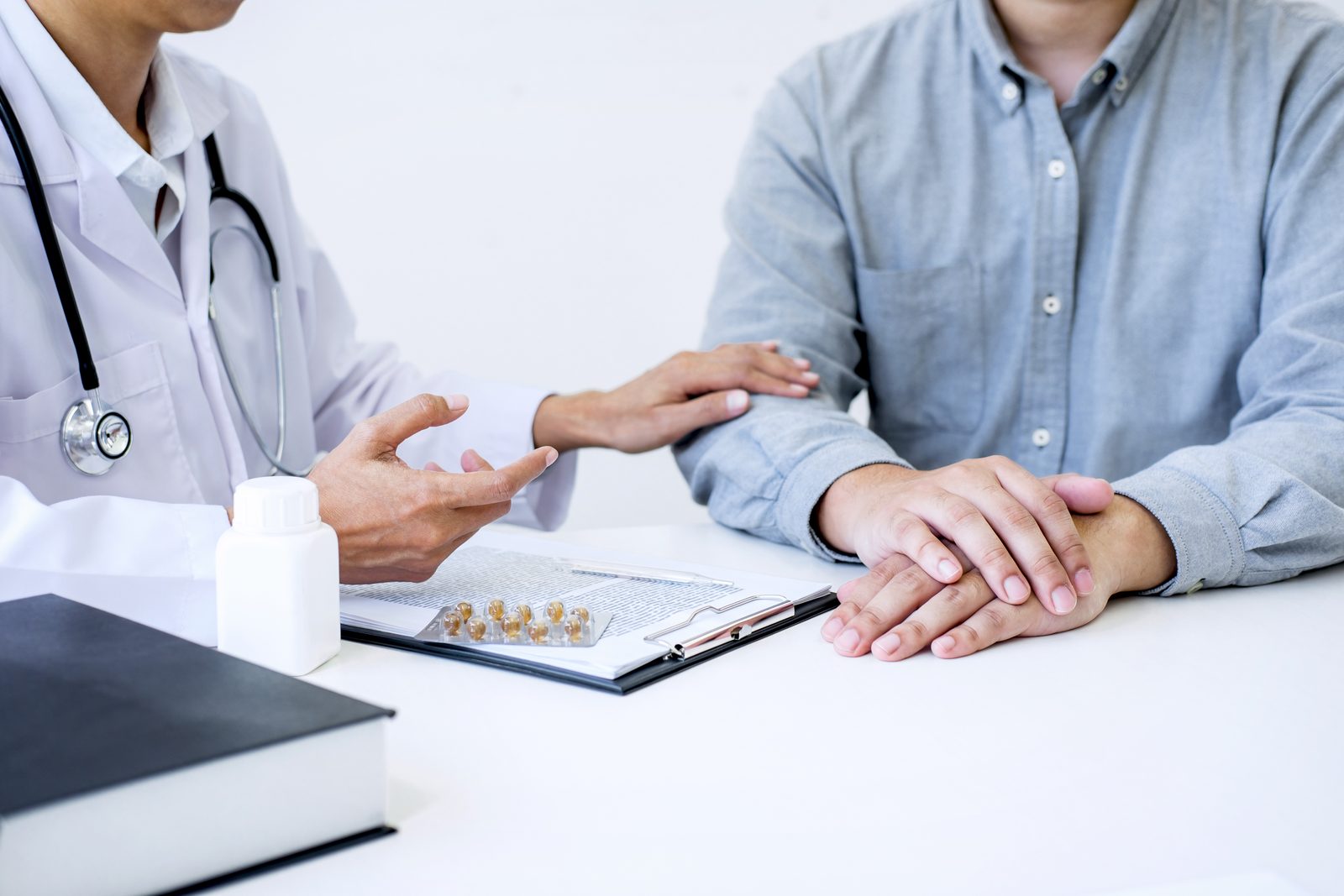 A physician discussing medication with a patient during a calm visit