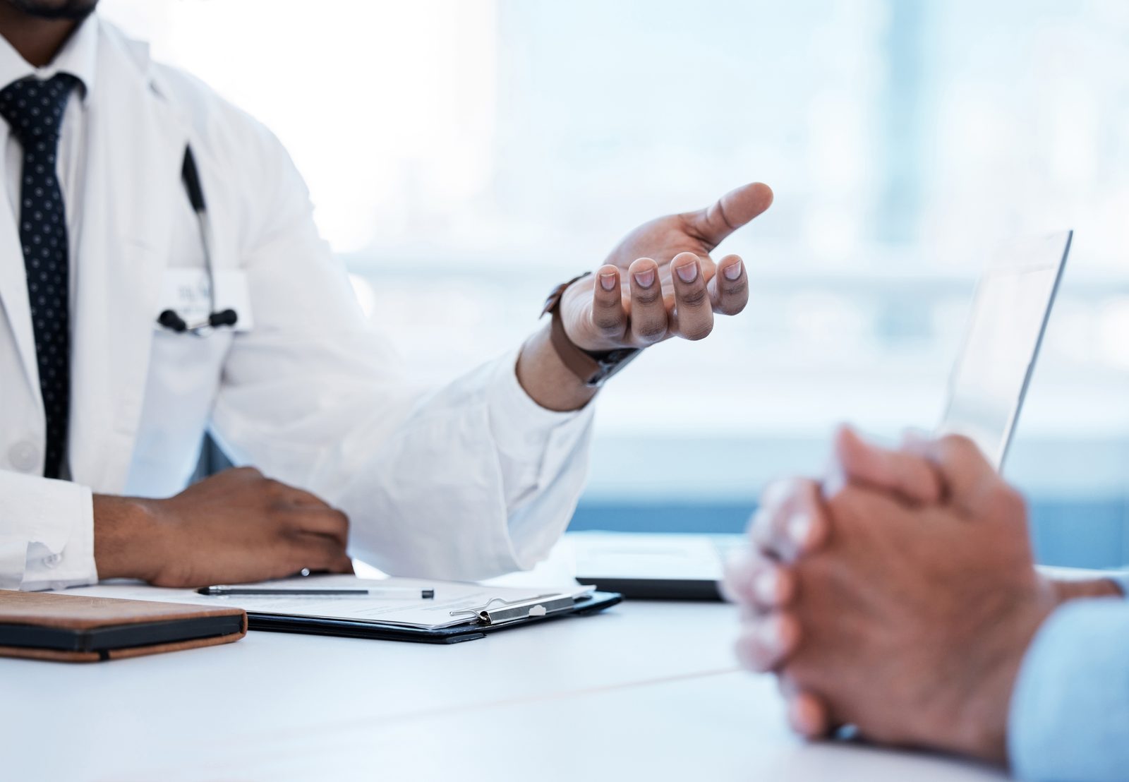 A physician speaking with a patient during a consultation